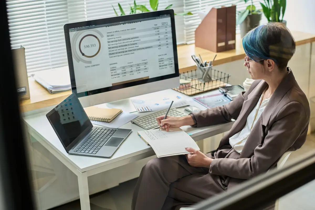 Business analysis charts and documents being reviewed on a desk